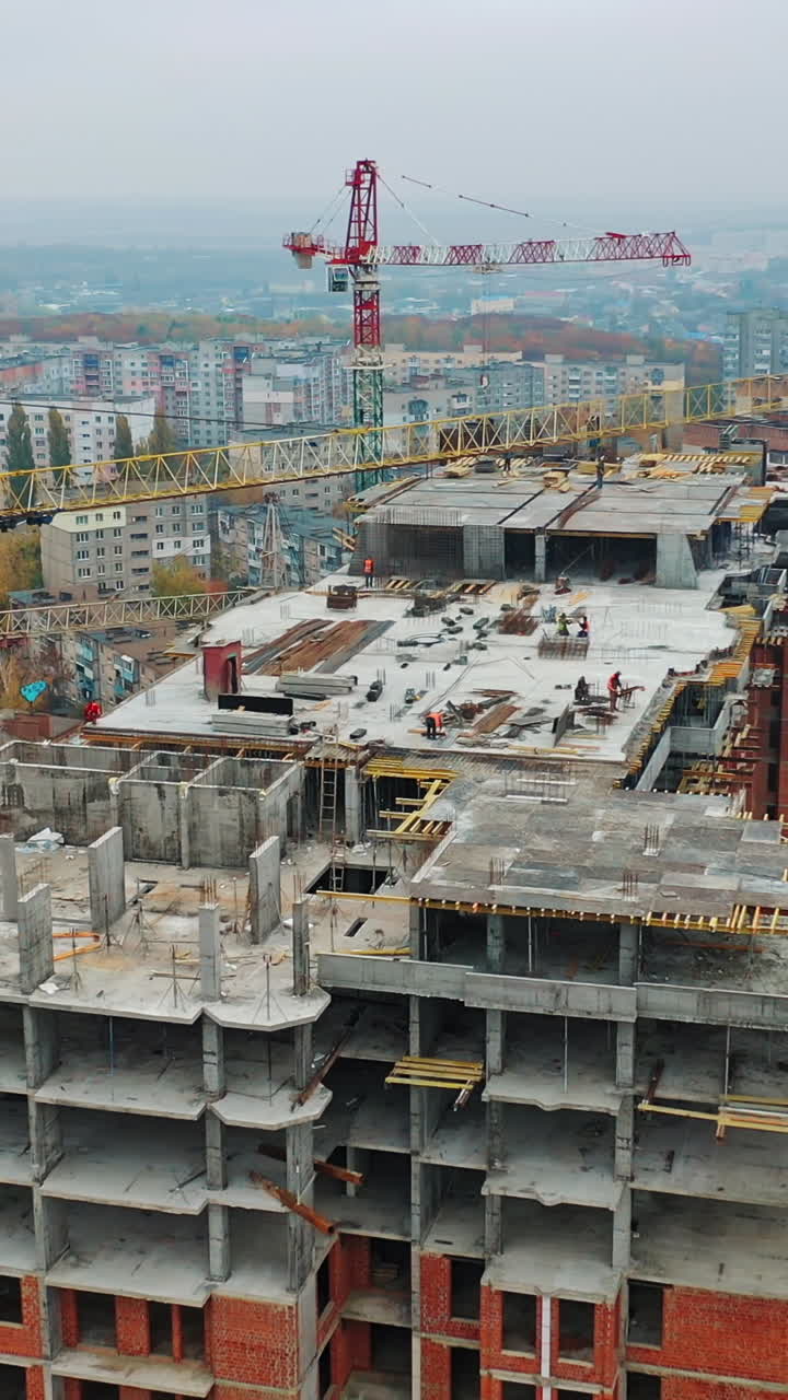 Construction site with cranes. Aerial shot of the skyscraper building in the process of construction