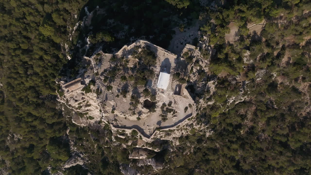 Top down drone descending above the Castle of Monolithos, in sunny Rhodes, Greece