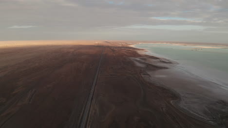 straight road by the salt lake with wide flatlands background.