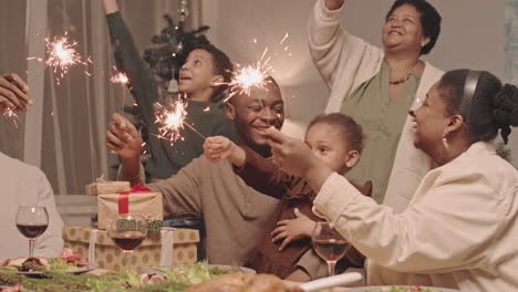 black family celebrating christmas with sparklers