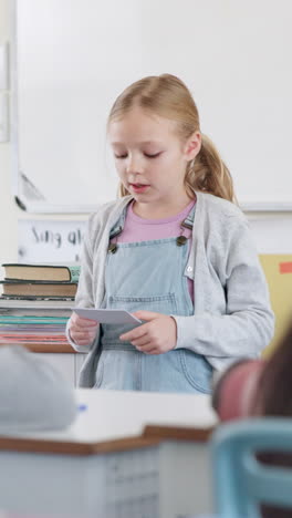 young schoolgirl giving a presentation in class