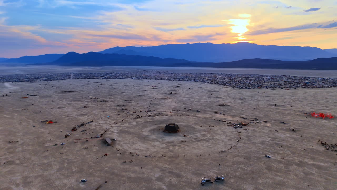 Sun set behind the mountain in the Black Rock Desert. Drone footage over the vast location of the Burning Man festival