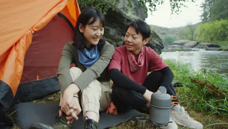 female tourists cooking food at campsite