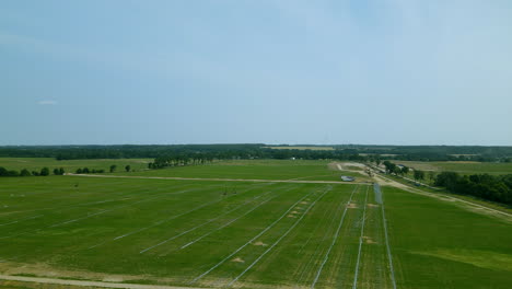aerial large green field for installation of photovoltaic panels, largest photovoltaic farm in central europe, renewable energy