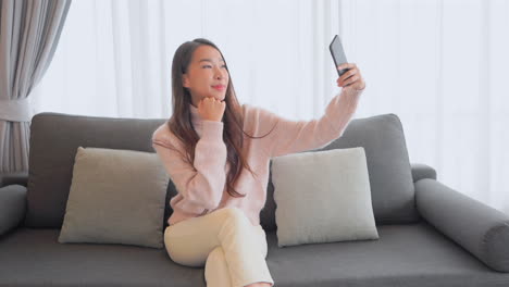 a pretty young woman searches for the best angle for her new selfie