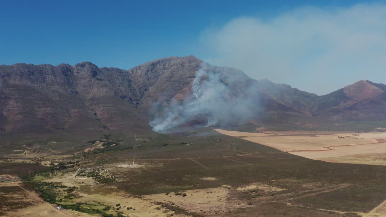 Wide Drone Shot of a Fire in the Mountains of a Farm in the Western Cape of South Africa