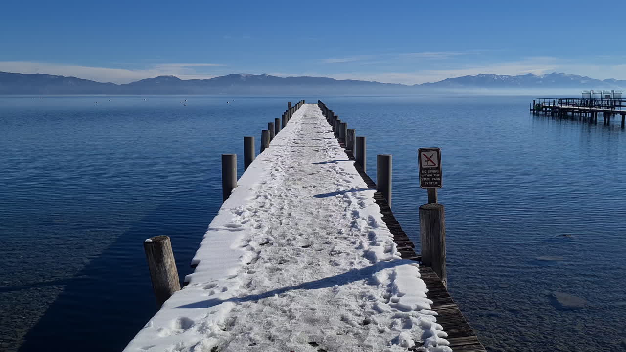 Empty Snow Capped Dock on Lake Tahoe USA on Sunny Winter Day