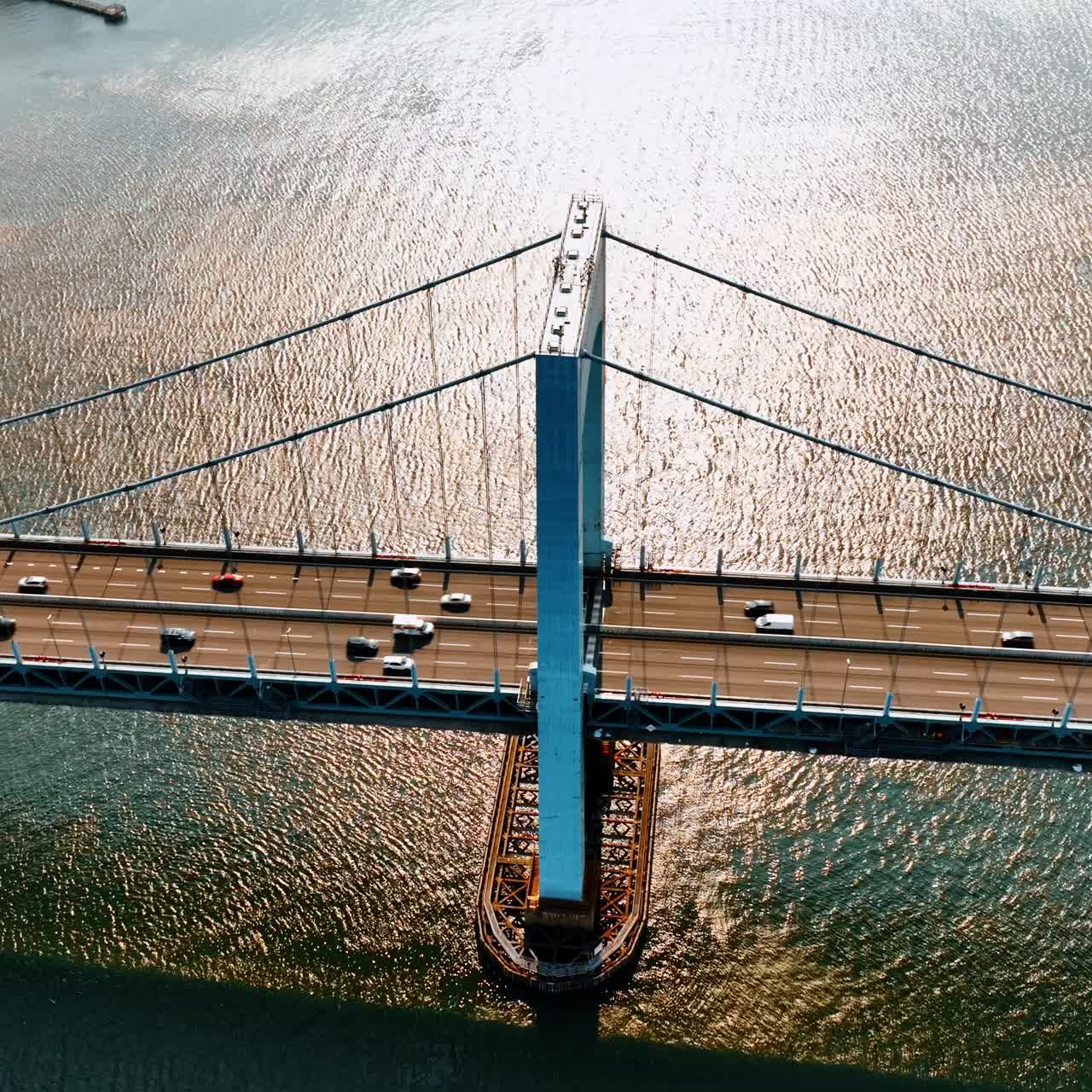Transport moving quickly by the Throgs Neck Bridge. Aerial view on the East River and suspension bridge on sunny day