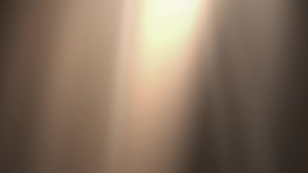 Soft Golden Light Rays Moving Across a Dark Background