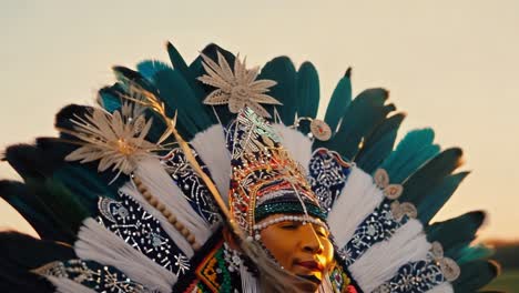 a native american dancer in traditional headdress and costume