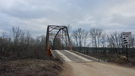 time-lapse footage of clouds moving in the sky above an old iron bridge