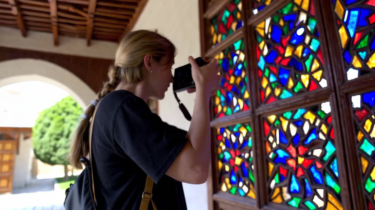 Woman Taking Photo of Stained Glass Window