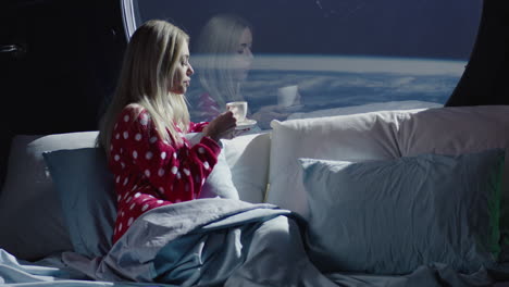 woman drinking coffee in space