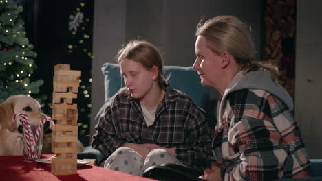 family playing with wooden blocks at christmas