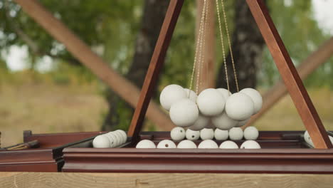 Board-game-with-wooden-field-and-suspended-white-balls