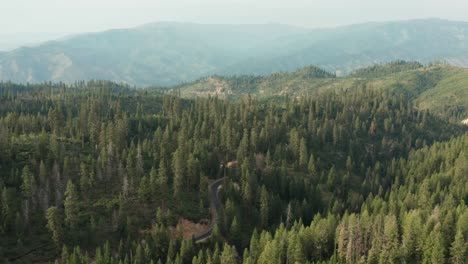 drone footage of a windy mountain road in the sawtooth mountains with a car driving