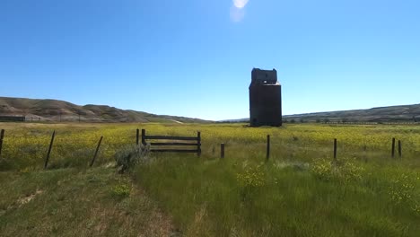 Old-wooden-grain-tower-in-the-country-near-Alberta-Canada-during-the-summer