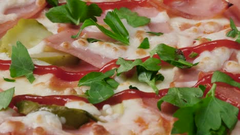 close-up of a pizza with ham, cheese, and parsley