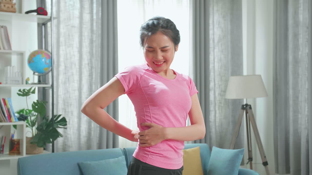 Asian Fitness Woman Pain Her Back In Living Room