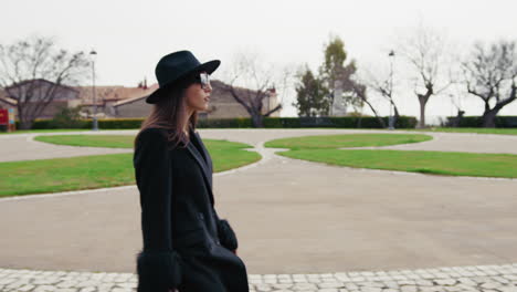 elegant woman arriving at the small town park during the day