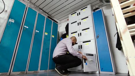 Low-angle-shot-of-Asian-Indian-Male-walking-towards-lockers