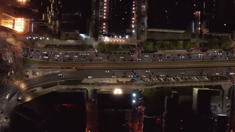 Aerial-birds-eye-overhead-top-down-panning-view-of-heavy-traffic-in-night-city.-Cars-are-stuffed-before-intersection.-Warsaw,-Poland