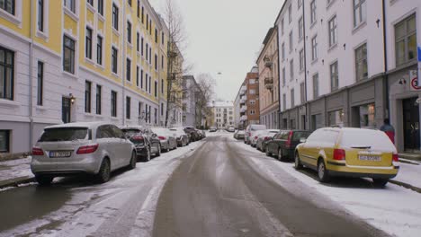 snowy city street in oslo 2, majorstuen neighborhood with cars, snow, winter