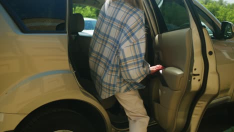 woman getting into a car