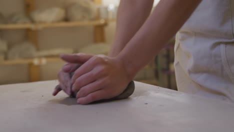 young female potter working in her studio