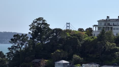 golden gate bridge reveal shot above homes in tiburon california