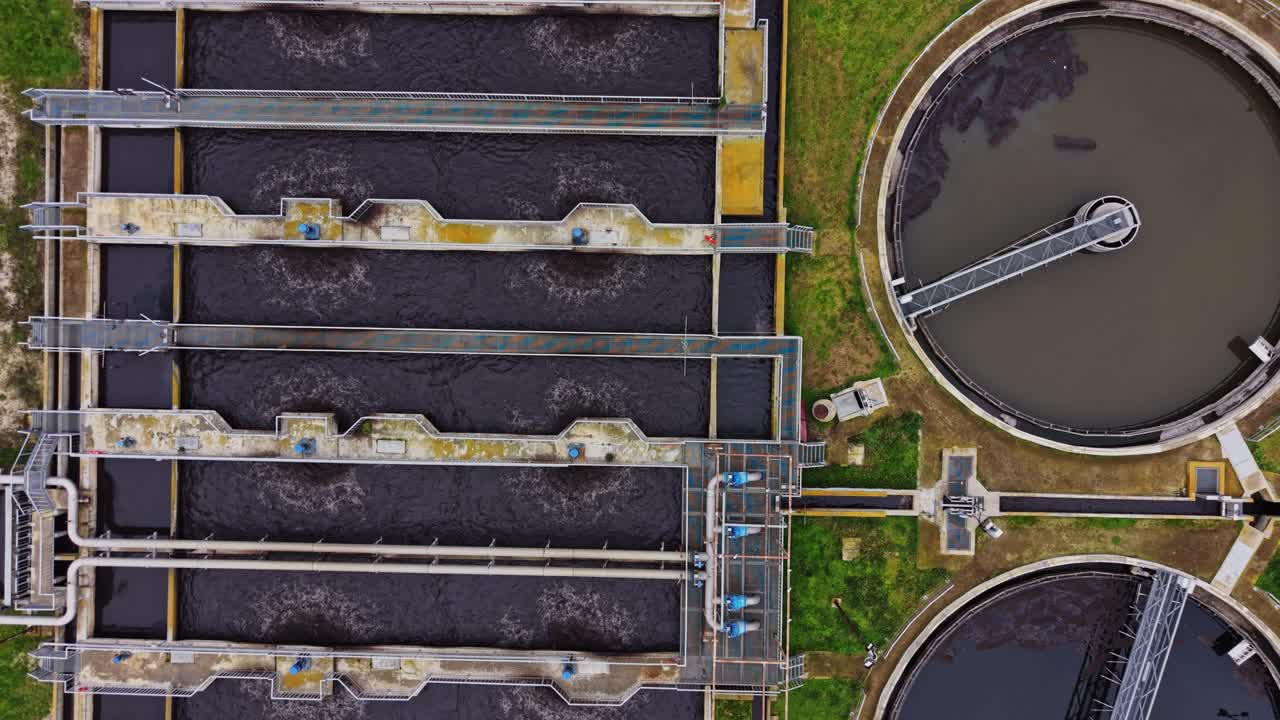 View of water treatment facility showing tanks and pipes in operation