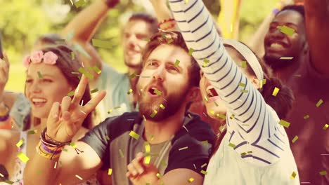 animation of gold confetti falling over happy people dancing outdoors