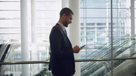 Businessman-talking-on-mobile-phone-in-the-lobby-at-office-4k