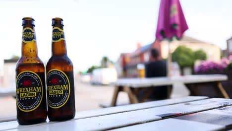 two beer bottles on a picnic table