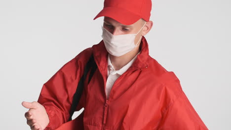 young courier boy spraying hand sanitizer on his hands