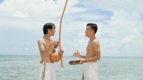 shirtless men playing musical instruments