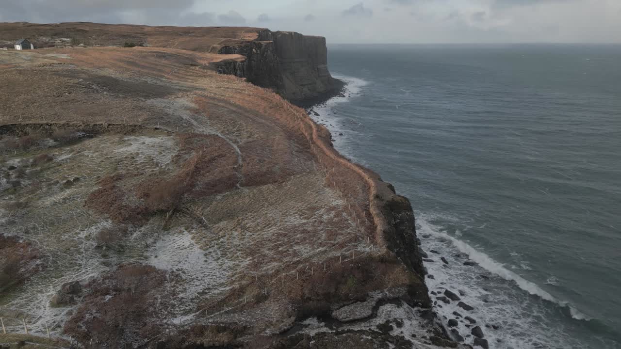 Kilt rock and the surrounding sea on the isle of skye, with a focus on the dramatic cliffs and coastline, aerial view