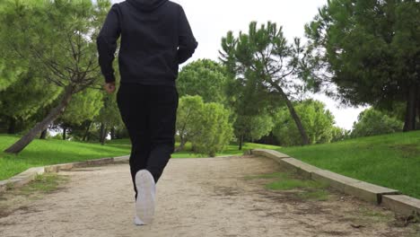 man running with his back to the camera tracking natural movement