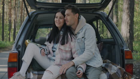 couple enjoying a road trip in the back of a car
