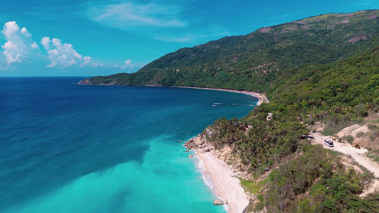 Aerial flight along beautiful coastline of Barahona with clear turquoise water and sandy beach. Dominican Republic paradise Caribbean sea