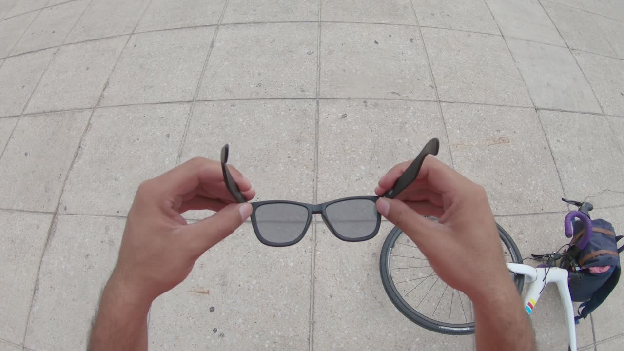 A Young Man's Hands Placing Sunglasses in His Face Slowly, POV