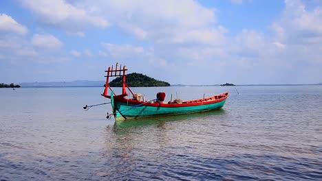 idyllic summer scene of the ambient motion of a traditional khmer fishing boat lulled in the gentle waves in koh sdach island in cambodia