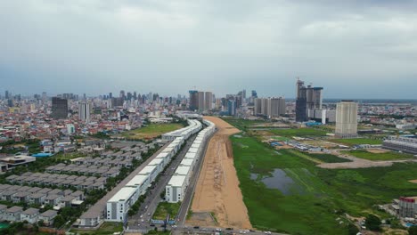 Aerial-cityscape-of-Phnom-Penh,-Cambodia’s-busy-capital,-cloudy-day-rainy-season