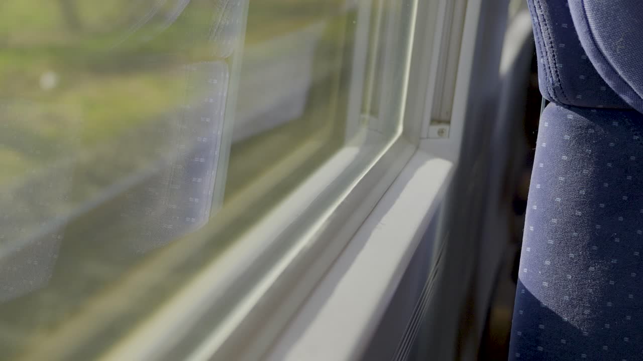 Inside a driving German ICE high-speed train, focusing on the window and seat