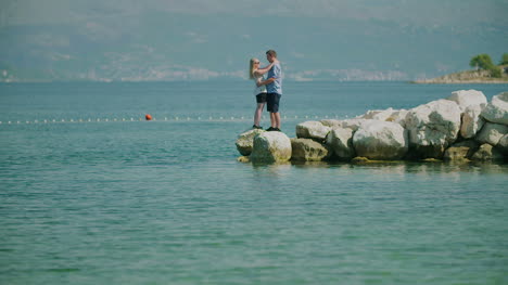 Couple-Holding-Hands-And-Walks-On-Shore