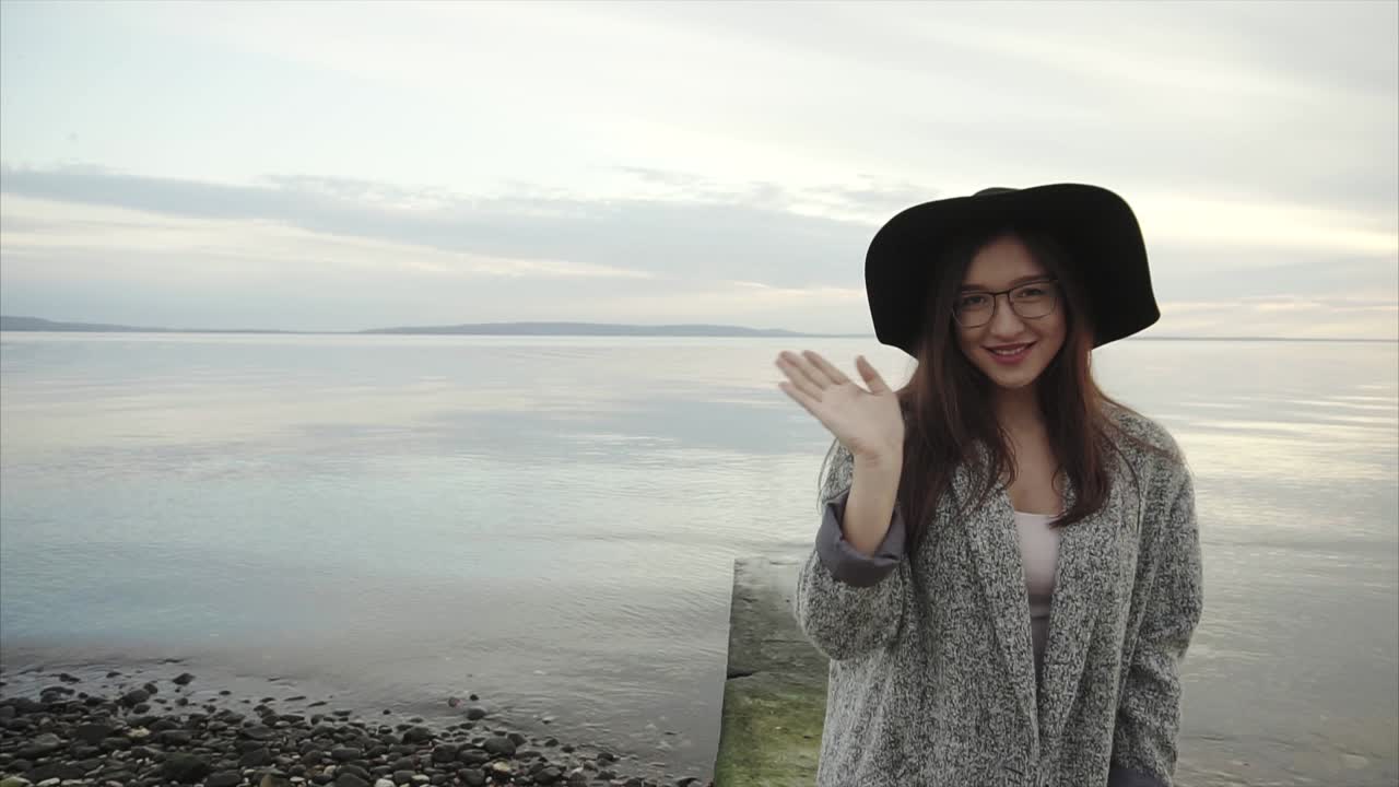 Woman waving at the beach