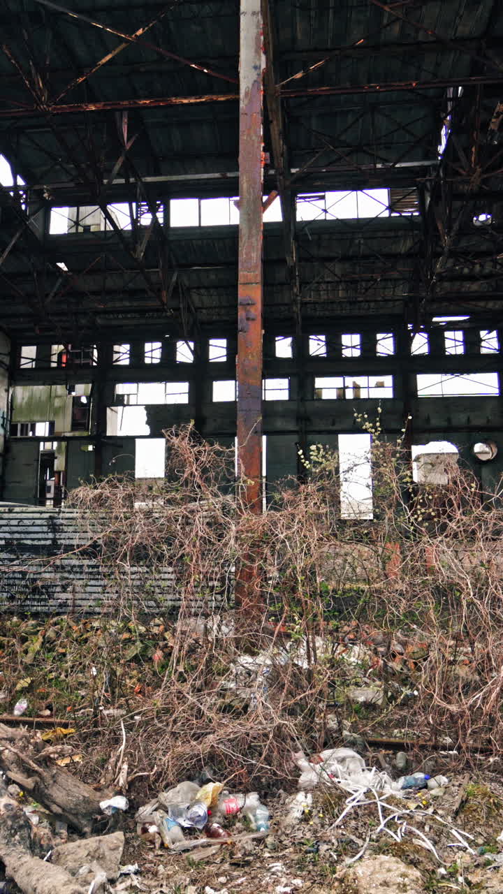 Abandoned factory interior. Old industrial building for demolition Vertical video
