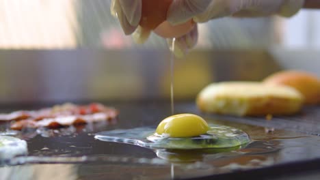 worker in fast food restaurant is placing egg on a grill to cook pouched egg slow motion