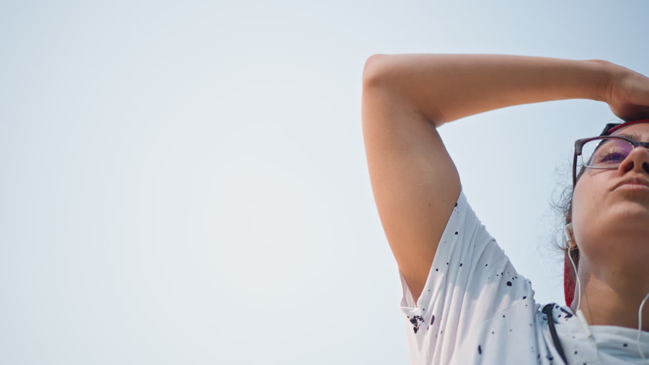 Youth dance expression, Youthful artist showcasing freestyle skills outdoors under blue sky, Young adult demonstrating spontaneous dance moves with vibrant energy and style on city street