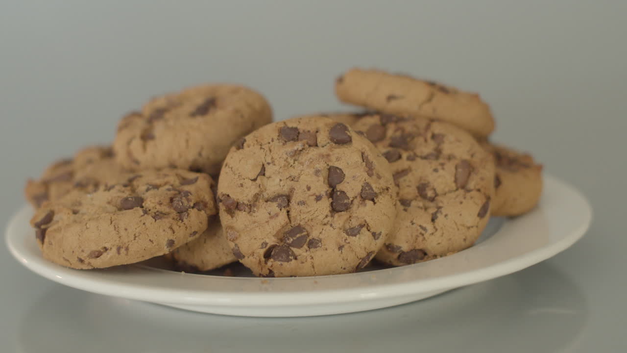 Dolly left of chocolate chip cookies on a white plate